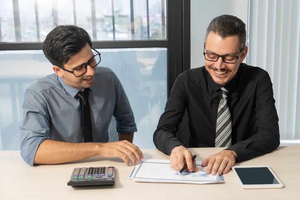 Business partners reviewing financial plans and business performance together